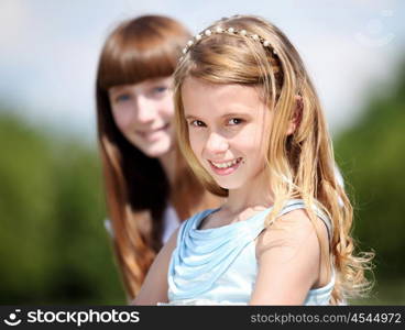 two girls spending time together in the summer park