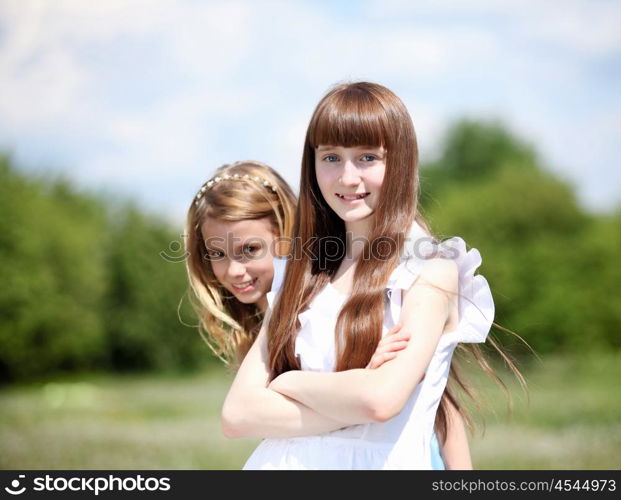 two girls spending time together in the summer park