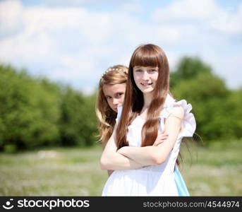 two girls spending time together in the summer park