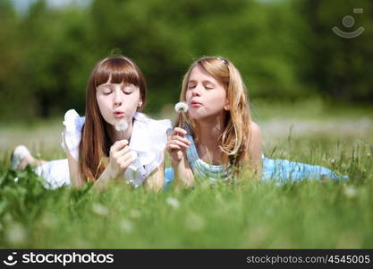 two girls spending time together in the summer park