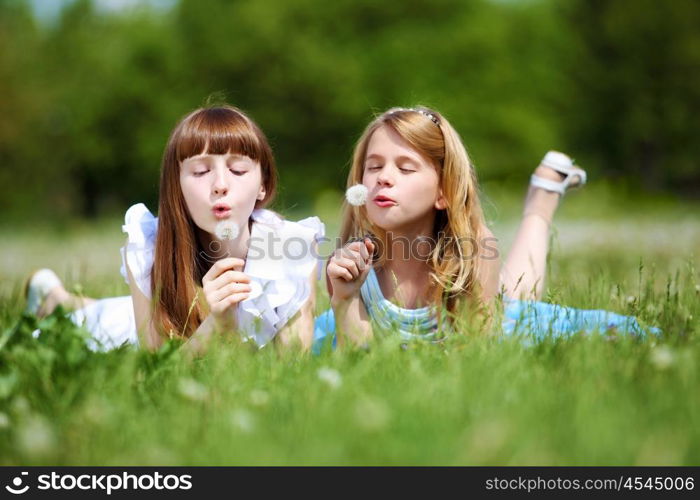 two girls spending time together in the summer park