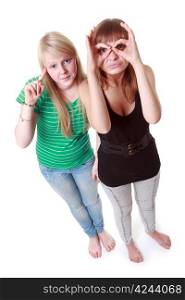 Two girls stand and make faces on white background