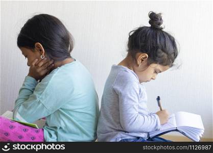 Two girls studying together