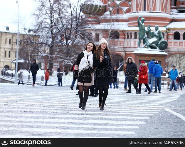 Two girls tourists are photographed in Moscow (Russia) winter 2015