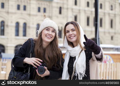 Two girls tourists are photographed in Moscow (Russia) winter 2015