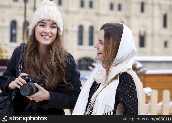 Two girls tourists are photographed in Moscow (Russia) winter 2015
