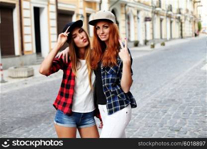 Two girls walking around giving peace sign