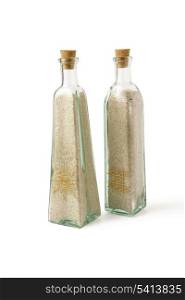 Two glass bottles full of sand
