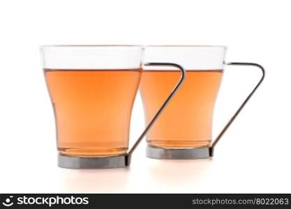 Two glass cups of black tea isolated on white background.
