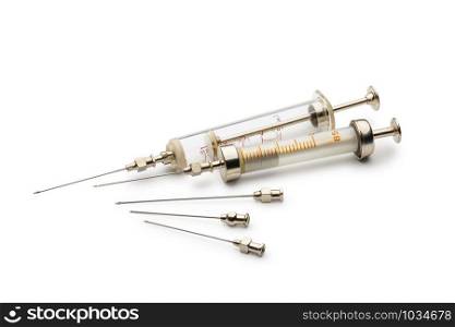 Two glass syringes and needles isolated on white background