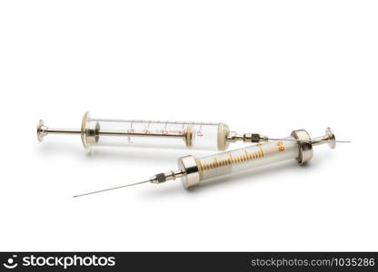 Two glass syringes isolated on white background