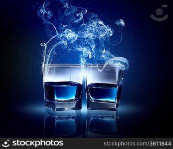 Two glasses o0 blue cocktail with fume going out