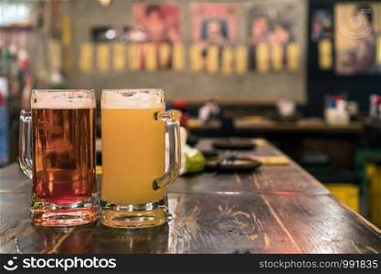 Two Glasses of Beer on the wooden table in bar and restaurant. relax and drink concept