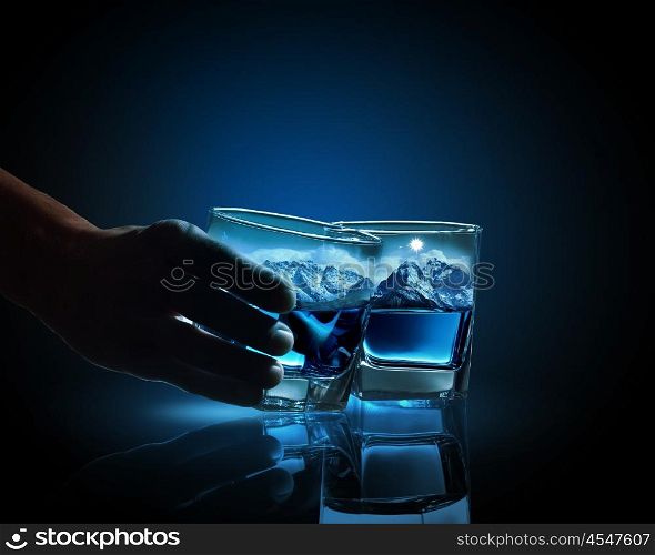 Two glasses of blue liquid. Two glasses of blue liquid with mountain illustration in