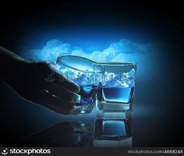 Two glasses of blue liquid. Two glasses of blue liquid with mountain illustration in