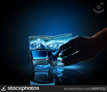 Two glasses of blue liquid. Two glasses of blue liquid with mountain illustration in