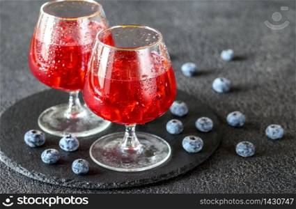 Two glasses of blueberry juice with fresh berries