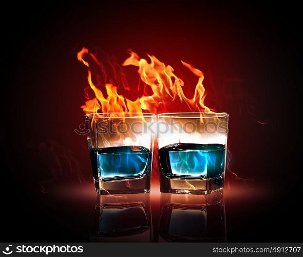 Two glasses of burning emerald absinthe. Image of two glasses of burning emerald absinthe