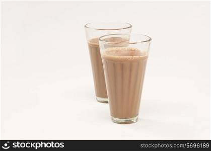 Two glasses of chai isolated over white background