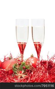 two glasses of champagne and angel figure at red Christmas balls and tinsel isolated on white background