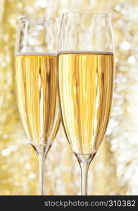 Two glasses of champagne on bokeh background for celebration