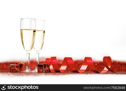 Two glasses of champagne with red decor, Valentines day concept. Champagne and red decor