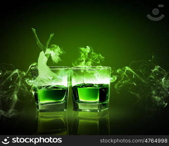 Two glasses of green absinth. Two glasses of green absinth with fairy