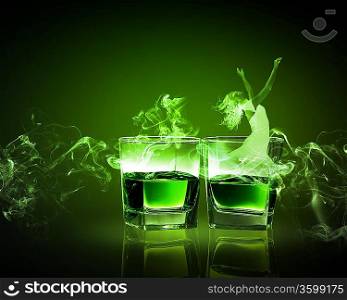 Two glasses of green absinth with fairy