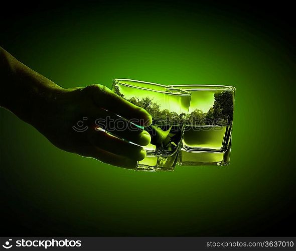 Two glasses of green absinth with nature illustration in