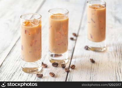 Two Glasses Of Irish Cream Liqueur On The Wooden Table