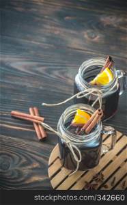 Two glasses of mulled wine on the wooden background