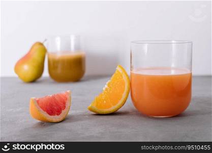 two glasses of orange and pear juice