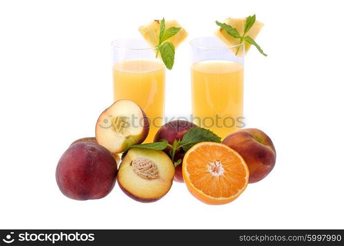 two glasses of orange juice with some fruits