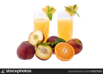 two glasses of orange juice with some fruits