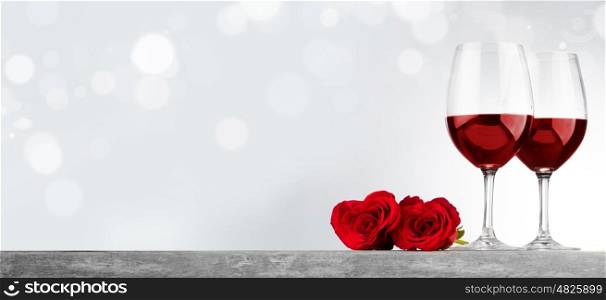 Two glasses of red wine and heart shaped roses, Valentine day