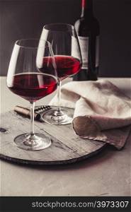 Two Glasses of red wine on concrete background. Glasses of red wine on concrete background