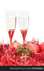 two glasses of sparkling wine and angel figure at red Christmas decorations isolated on white background
