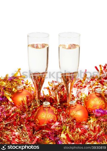 two glasses of sparkling wine at yellow and orange Xmas decorations isolated on white background