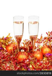 two glasses of sparkling wine at yellow and orange Xmas decorations isolated on white background