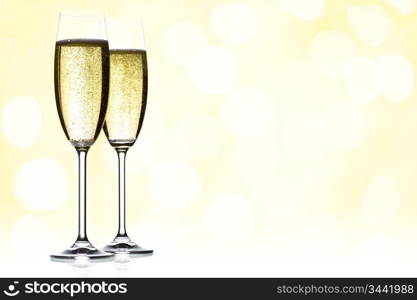 two glasses of sparkling wine with copyspace and abstract lights background