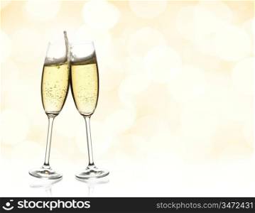two glasses of sparkling wine with copyspace and abstract lights background