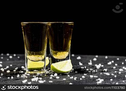two glasses of tequila with lime and salt