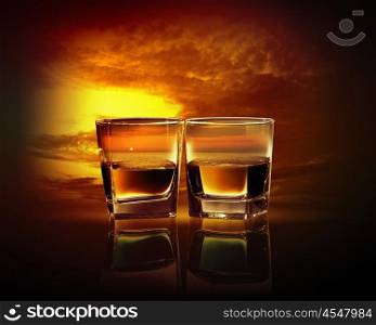 Two glasses of whiskey. Two glasses of whiskey with sea illustration in against sky background
