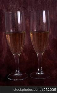 Two glasses of white wine isolated on painted background