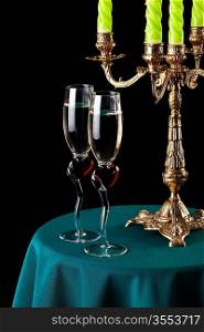 two glasses of wine and a candlestick on the table