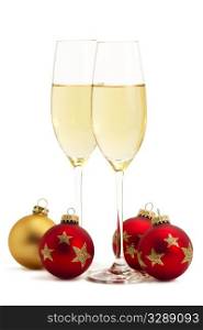 two glasses with champagne with one golden and three red christmas balls. two glasses with champagne with one golden and three red christmas balls on white background