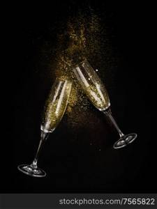 Two glasses with Christmas amd Happy New Year Champagne over black background. Christmas amd Happy New Year Champagne
