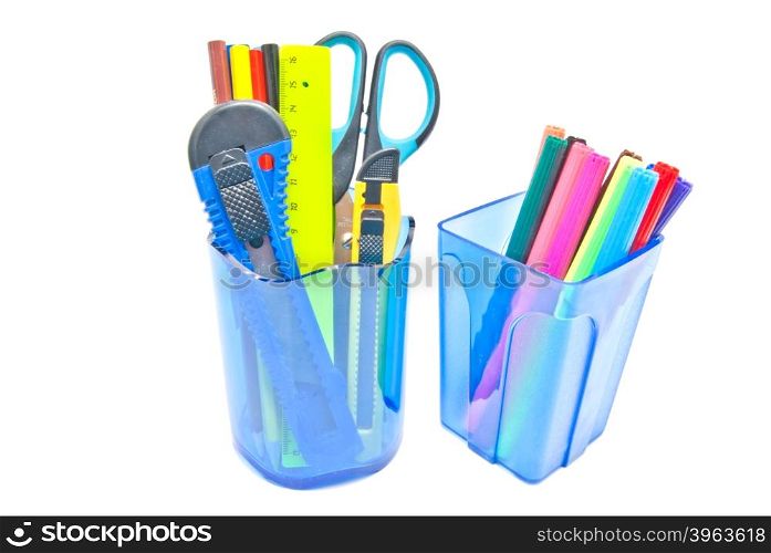 two glasses with office supplies on white background