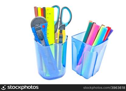 two glasses with office supplies on white background