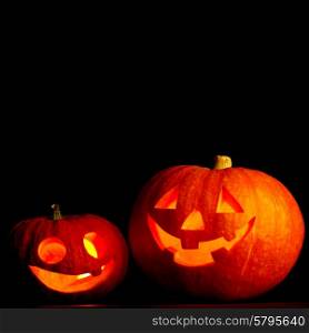 Two glowing Halloween pumpkins isolated on black background. Halloween pumpkins